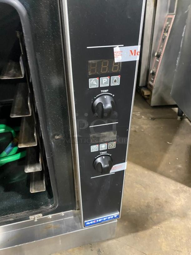 Moffat TurboFan G32D5 commercial convection oven, stainless steel, gas-powered, 5-pan capacity, built-in pan slide, blue gas connector hose, model G32D5 SN: 755326, control panel with temp and timer knobs.