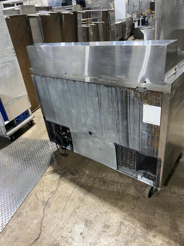 Atosa MSF8302 stainless steel 2-door refrigerated prep table, bain marie style, on casters, visible wear, with poly-coated rack.