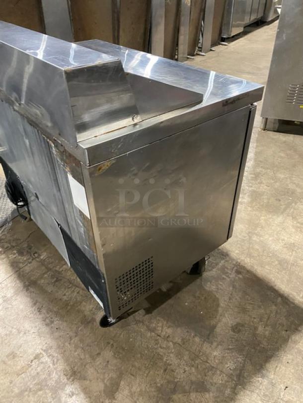 Atosa 2-door refrigerated prep table, stainless steel, model MSF8302, on casters, with poly-coated rack, minor wear visible.