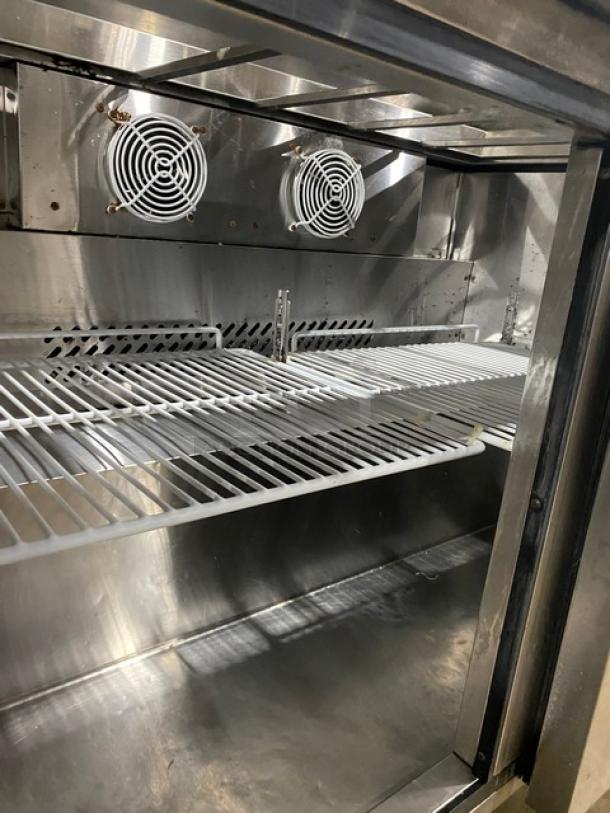 Atosa stainless steel 2-door refrigerated prep table, Model MSF8302, with poly-coated rack, on casters, 115V, 1 phase.