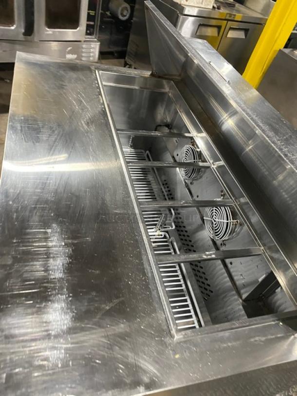 Atosa stainless steel 2-door refrigerated bain marie style prep table, model MSF8302, with poly coated rack, on casters.