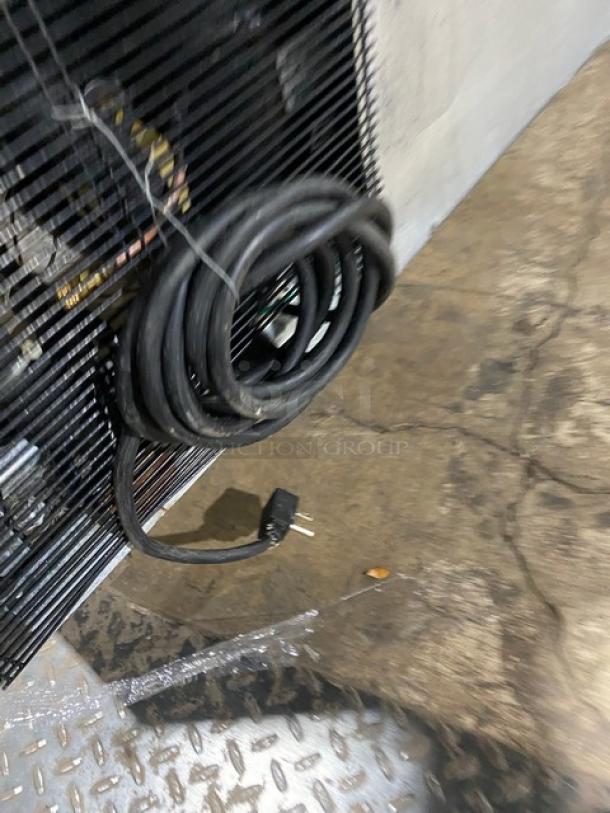 Atosa MSF8302 refrigerated prep table power cord, coiled and plugged in. Features 115V compatibility, on casters.
