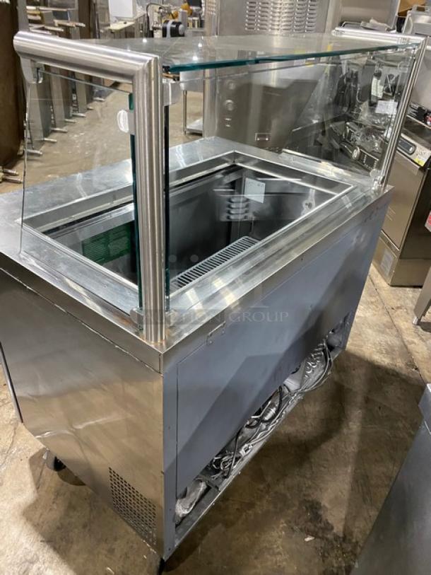 Atosa MSF8306 commercial stainless steel prep table with sneeze guard, poly-coated rack, on casters, 115V, excellent condition.