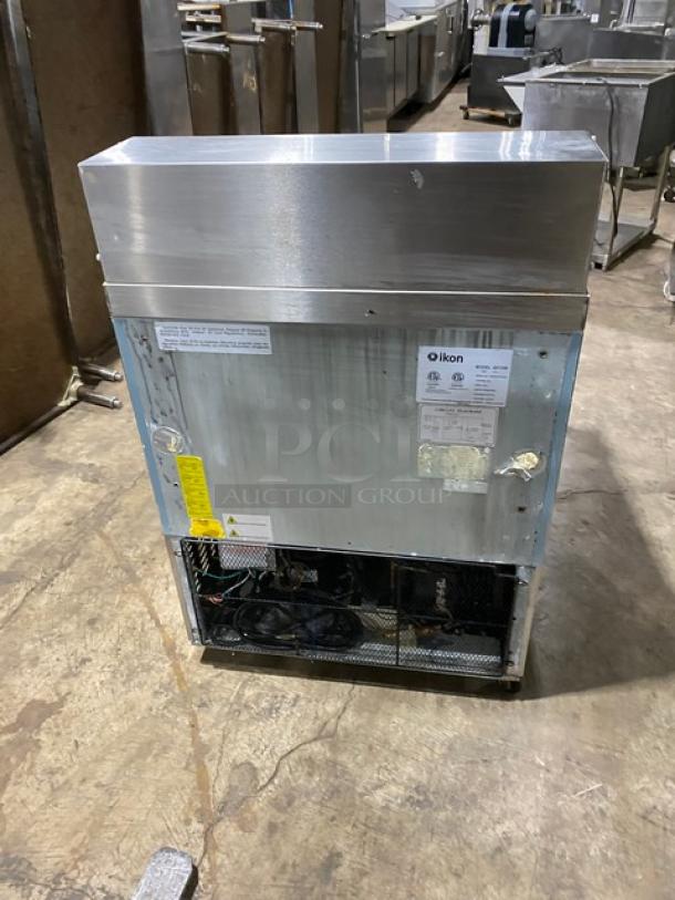 Ikon stainless steel single door refrigerated prep table, Model ISP29M, with poly coated rack, on casters, in used condition.