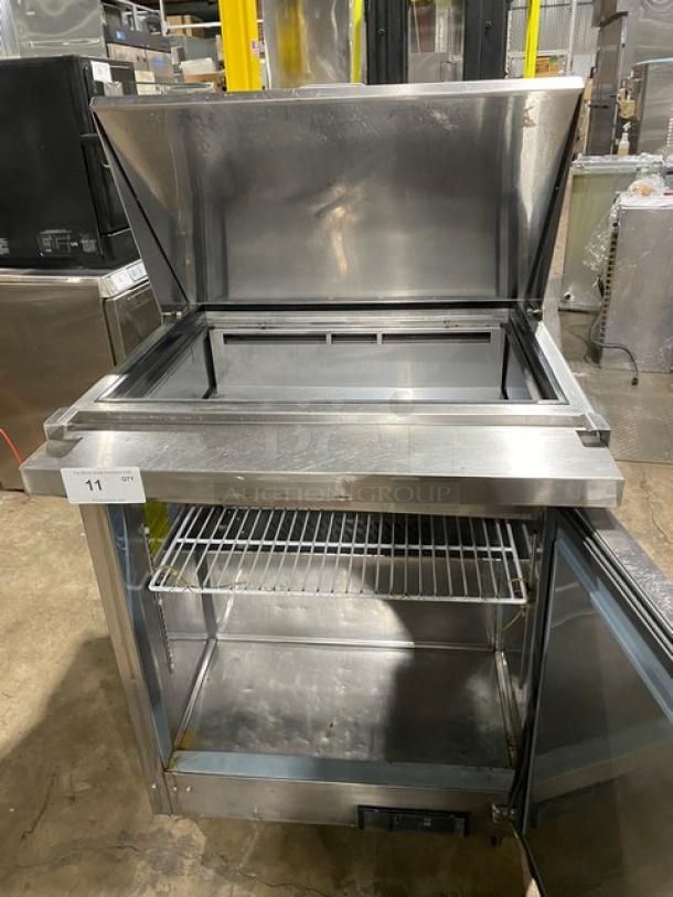 Ikon stainless steel refrigerated prep table, Model ISP29M, with open top, poly coated rack, on casters, SN: ISP29M20176648.