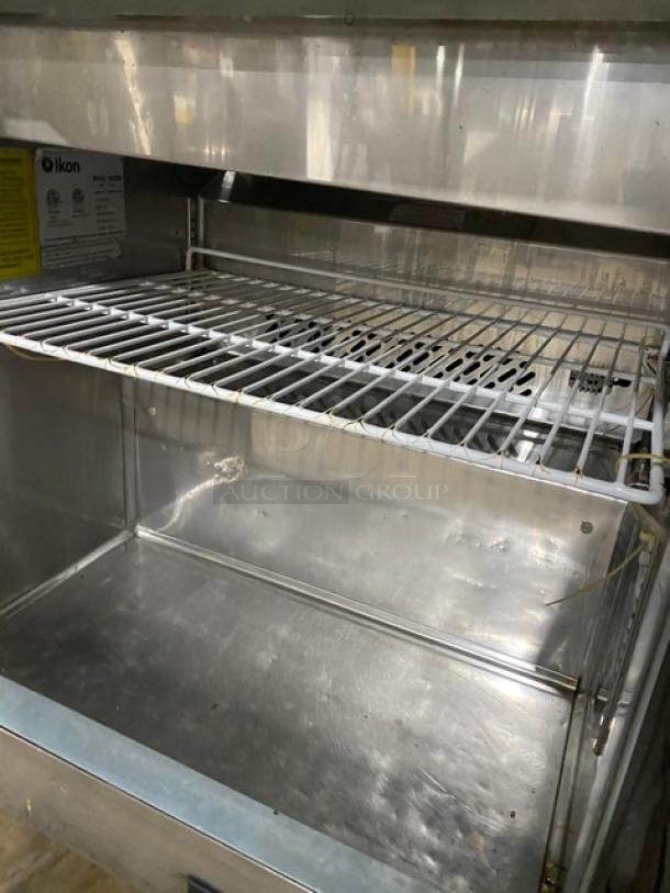 Ikon ISP29M stainless steel refrigerated prep table with poly coated rack, single door, on casters, serial ISP29M20176648.