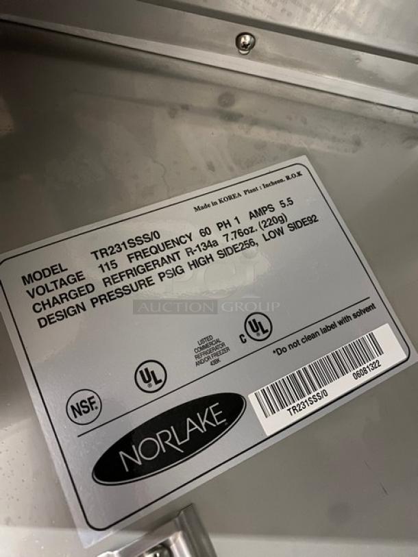 Norlake stainless steel reach-in refrigerator, model TR231SSS/0, 115V, on casters. Features poly-coated wired rack.