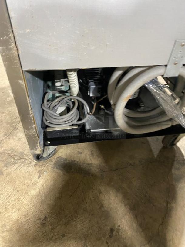 Norlake TR231SSS0 stainless steel reach-in refrigerator, features poly-coated rack, on casters, 115V, single-phase, visible wear.