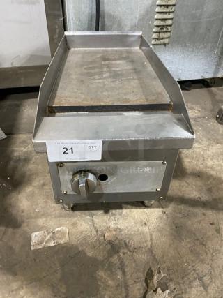 Commercial stainless steel natural gas countertop flat griddle with back and side splash, on adjustable legs, used condition.