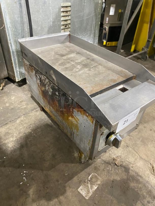 Commercial stainless steel natural gas countertop flat griddle with back and side splash, on legs. Used condition.
