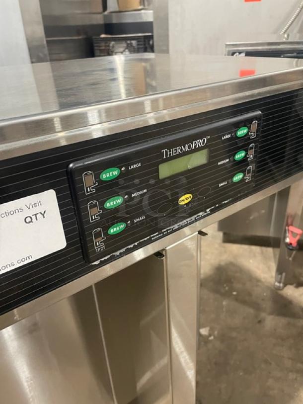 Curtis ThermoPRO TP2T10A3100 commercial coffee brewer, stainless steel, twin server, with hot water dispenser, 220V, on legs.
