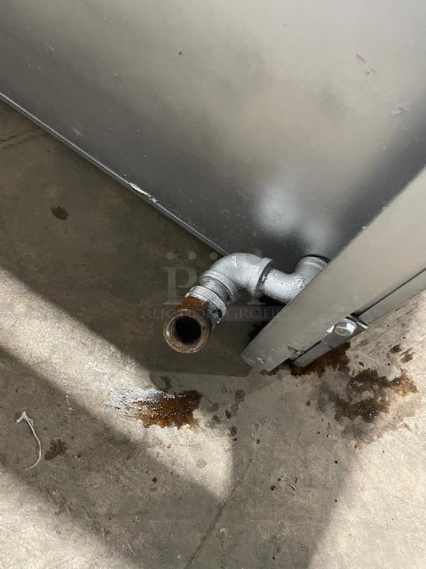 Jade Range stainless steel natural gas overhead salamander broiler/cheese melter pipe detail on floor, showing gas connection.