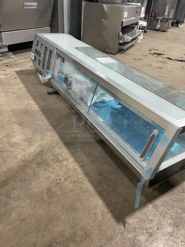 Marchia 53" curved glass refrigerated sushi display, model MSU150S. Features LED lights, glass sliding doors, and new pans.