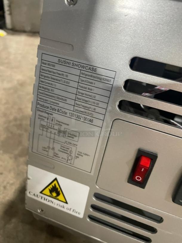 Marchia stainless steel sushi display, model MSU150S, SN: 1301302100046. Features include a power switch and safety warning label.