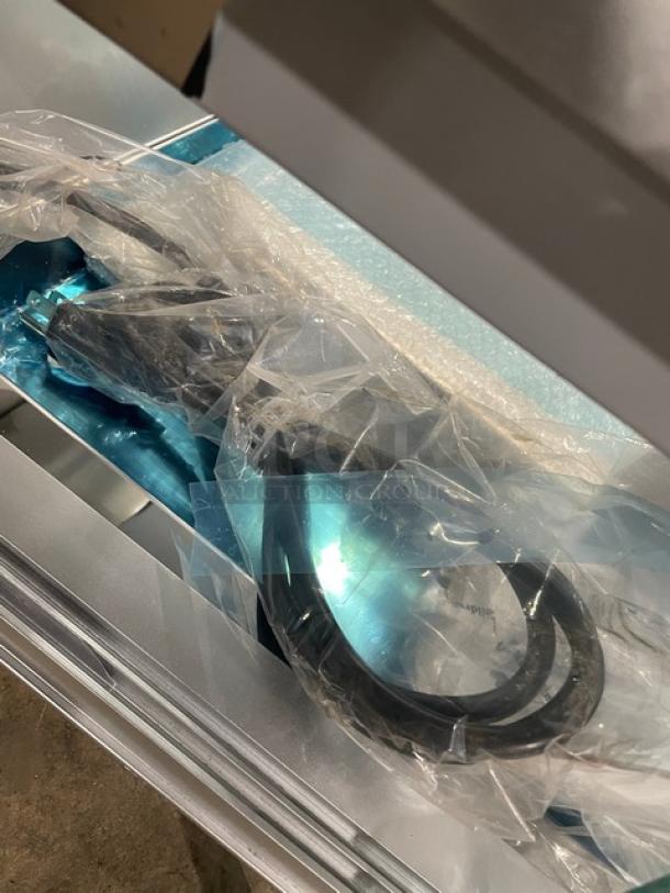 Marchia MSU150S sushi display showcase with stainless steel finish, LED lights, and 5-pan capacity, wrapped in protective plastic.