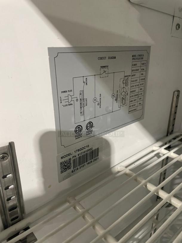 Avantco commercial refrigerator, Model 178GDC10, white interior, poly-coated racks, circuit diagram label visible.