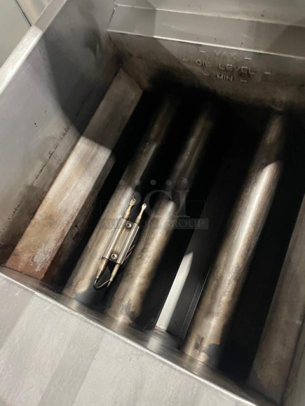 Pitco Model 35C+S commercial stainless steel deep fat fryer with back splash, showing interior burners and oil level markings.