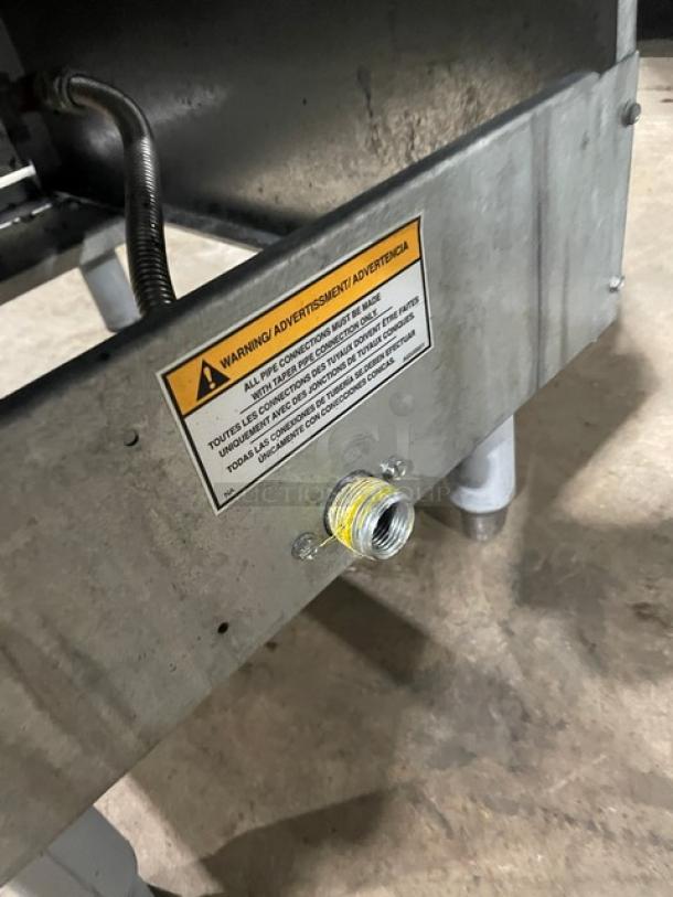 Pitco 35C+S stainless steel liquid propane deep fat fryer, 35 lb capacity, with back splash and fry baskets, warning label visible.