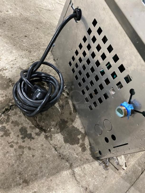 Follet 15CI100A stainless steel countertop ice/water dispenser, electric, 115V 1 Phase, with drip tray, cord coiled beside unit.
