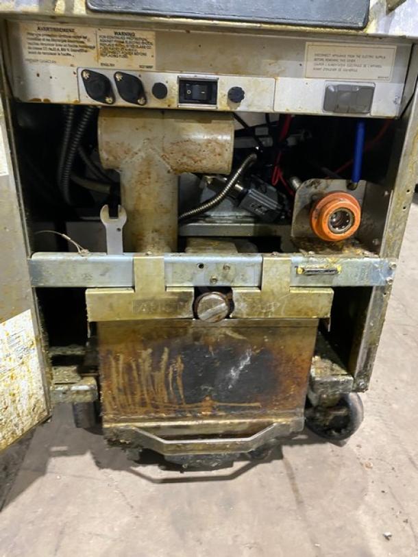 Frymaster FilterQuick Series electric fryer, model 1FQE80U0ZQTZB17, on casters, showing interior components and wear.