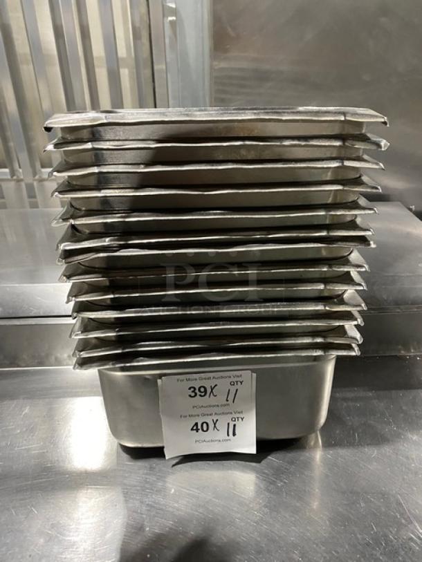 Commercial stainless steel steam table pans, stack of 11, used condition. Labels show auction quantity details.