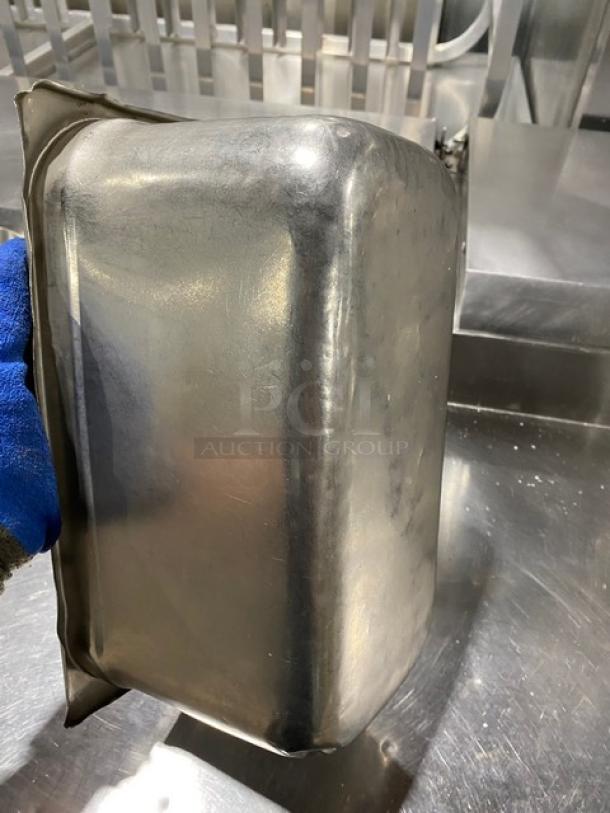 Commercial stainless steel steam table pan, shown in a used condition, highlighting its durable material and size.