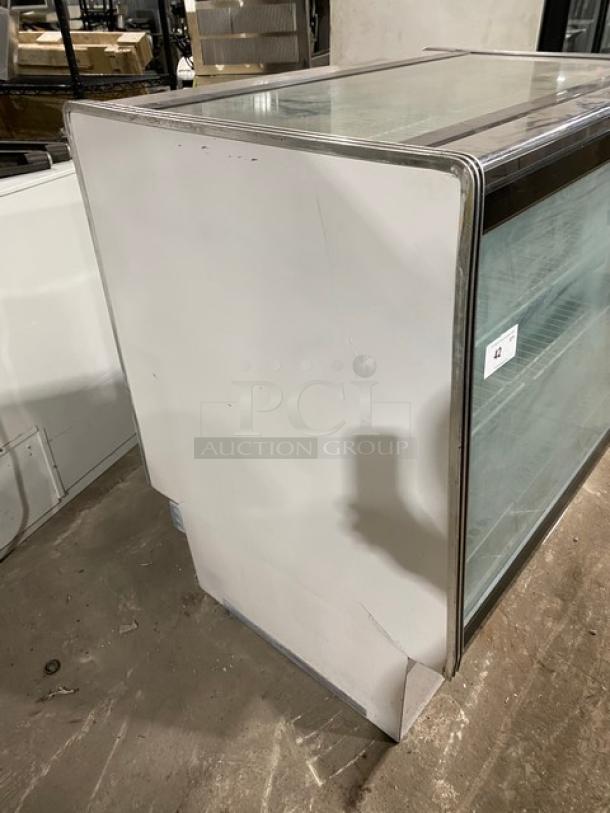 Commercial white 48" straight glass refrigerated meat deli display case with poly coated rack and rear sliding doors.