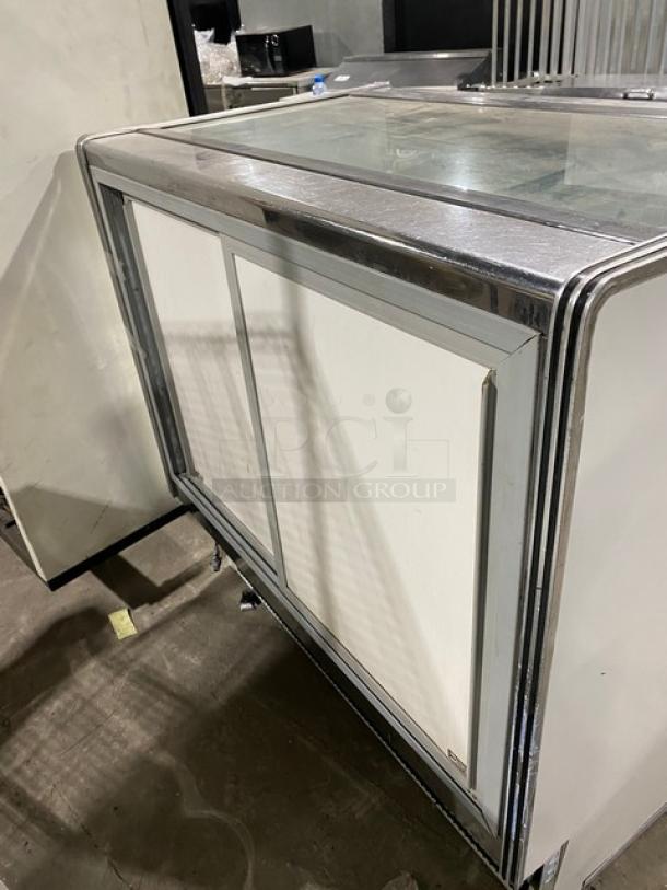 Commercial 48" white refrigerated deli display case with straight glass, poly coated wire rack, rear sliding doors.