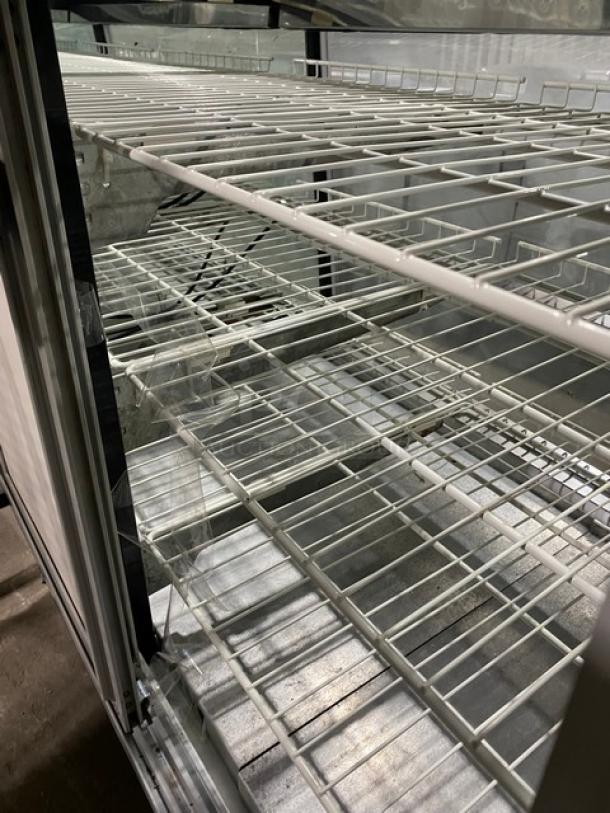 Commercial 48" refrigerated deli display case, straight glass, white, with poly-coated wired rack and rear sliding doors.