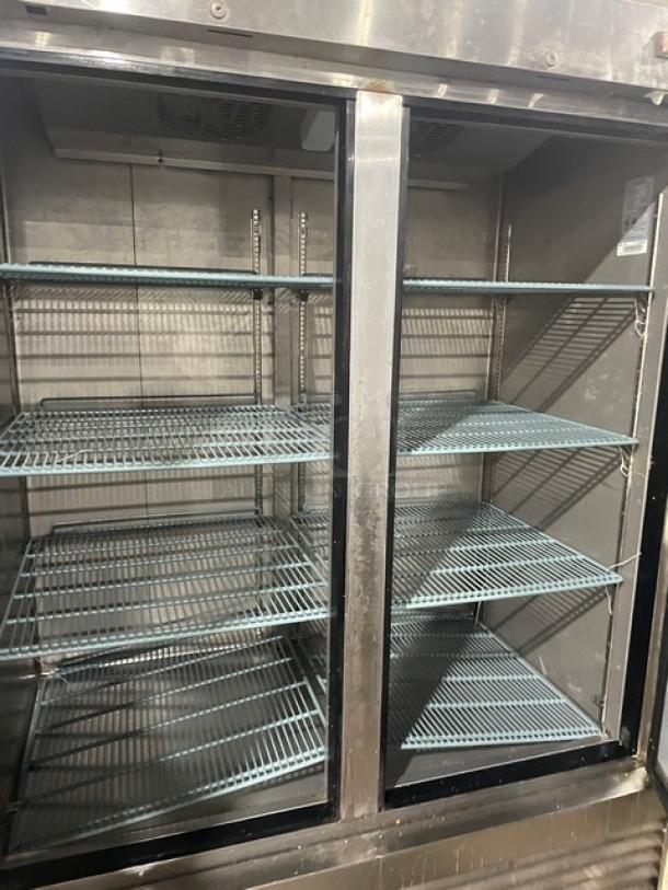 Duker's Model D55F 2-door stainless steel reach-in freezer with poly-coated wire racks, on casters.