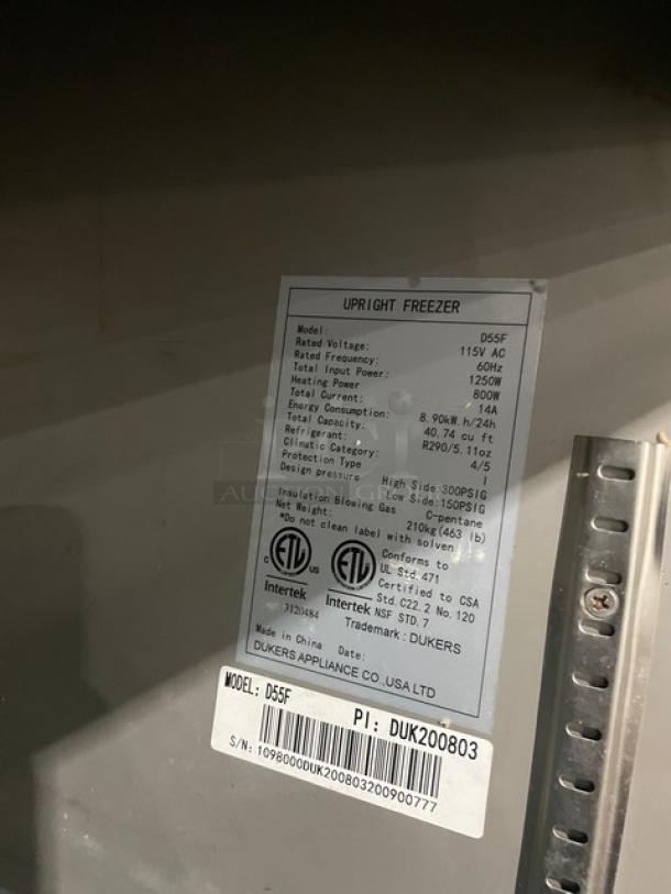 Duker's D55F Commercial Stainless Steel 2-Door Freezer, 115V, with poly-coated wire rack, on casters, model and serial number tags visible.