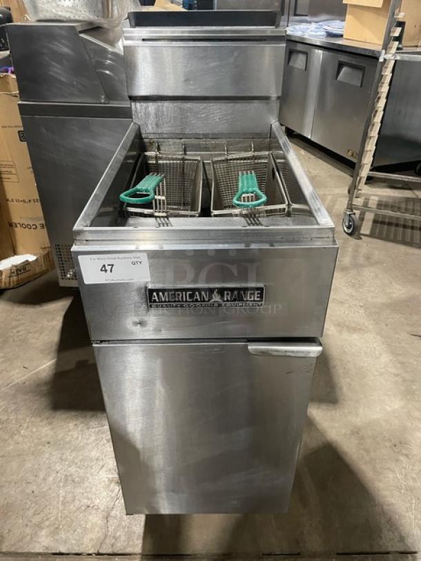 American Range commercial stainless steel deep fat fryer with basket hanger, backsplash, and fry basket, on legs.