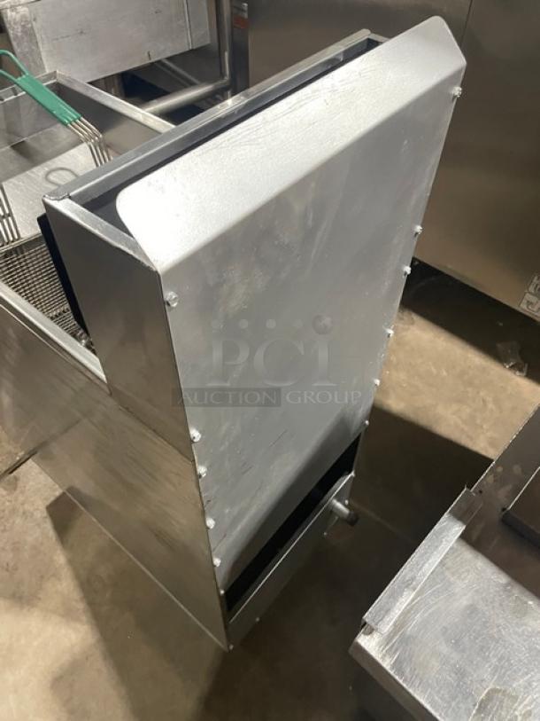 American Range stainless steel natural gas deep fat fryer with back splash, basket hanger, and fry basket. On legs.