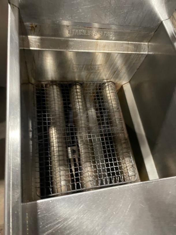 American Range stainless steel deep fat fryer with basket hanger and backsplash. Natural gas powered, on legs.