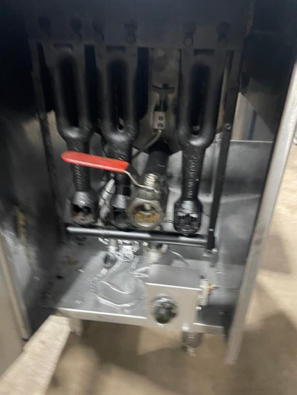 American Range stainless steel natural gas deep fat fryer, with backsplash, basket hanger, and fry basket, on legs.