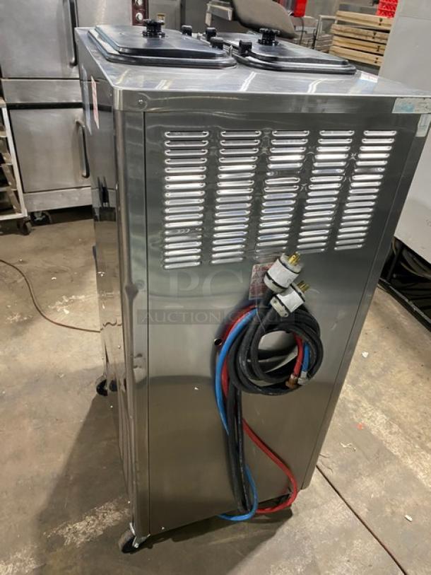 Taylor C713-33 stainless steel dual flavor soft serve machine, electric, 2 hoppers, 208-230V, on casters.