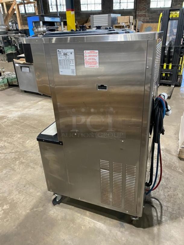 Taylor C713-33 stainless steel dual flavor soft serve machine on casters. Features two hoppers, electric, 208-230V 3 phase.