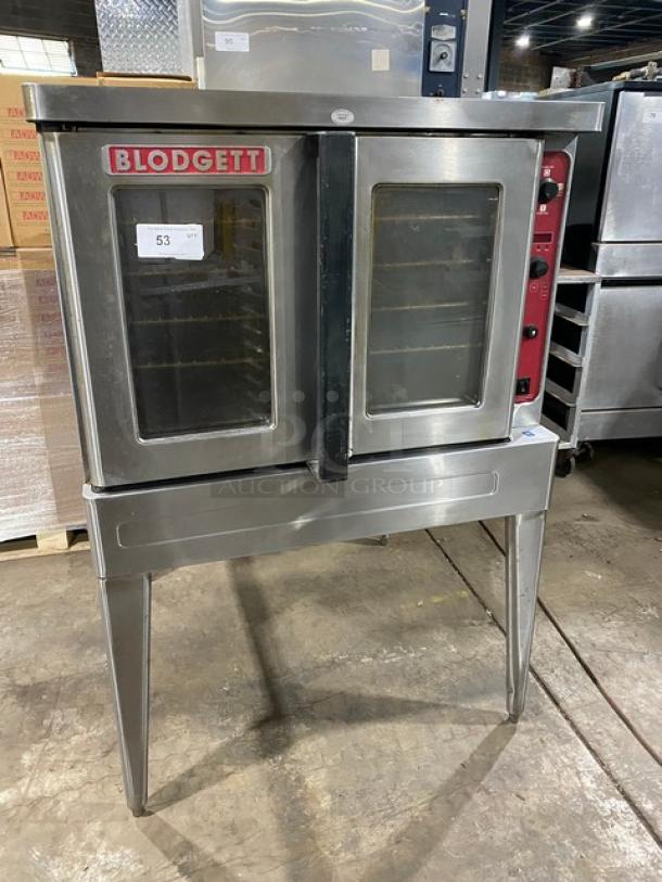 Blodgett stainless steel electric convection oven, single stacked, with wired rack, mounted on legs. Visible label: "Blodgett."