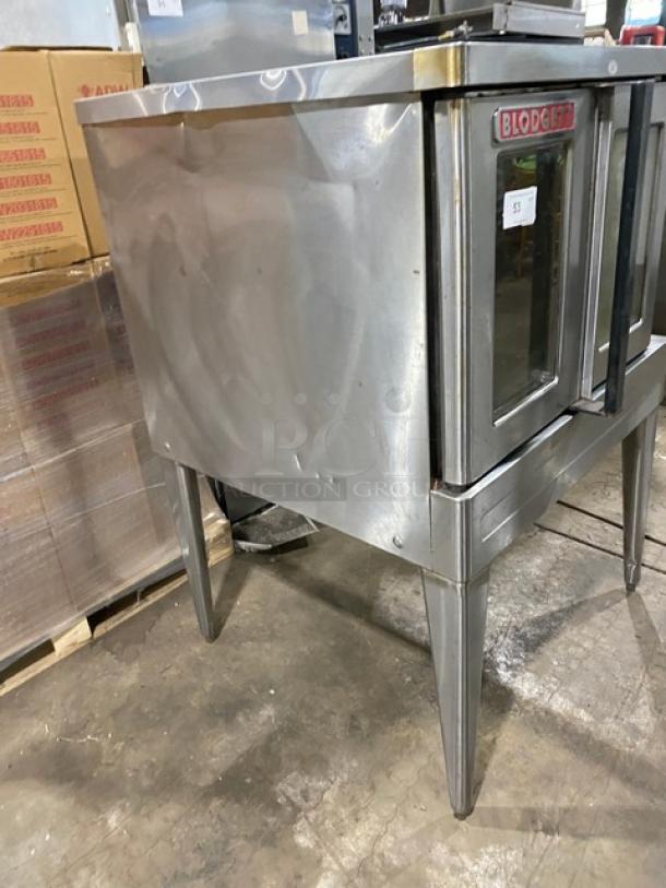 Blodgett commercial stainless steel electric convection oven, single stacked, with wired rack, on legs, visible wear.