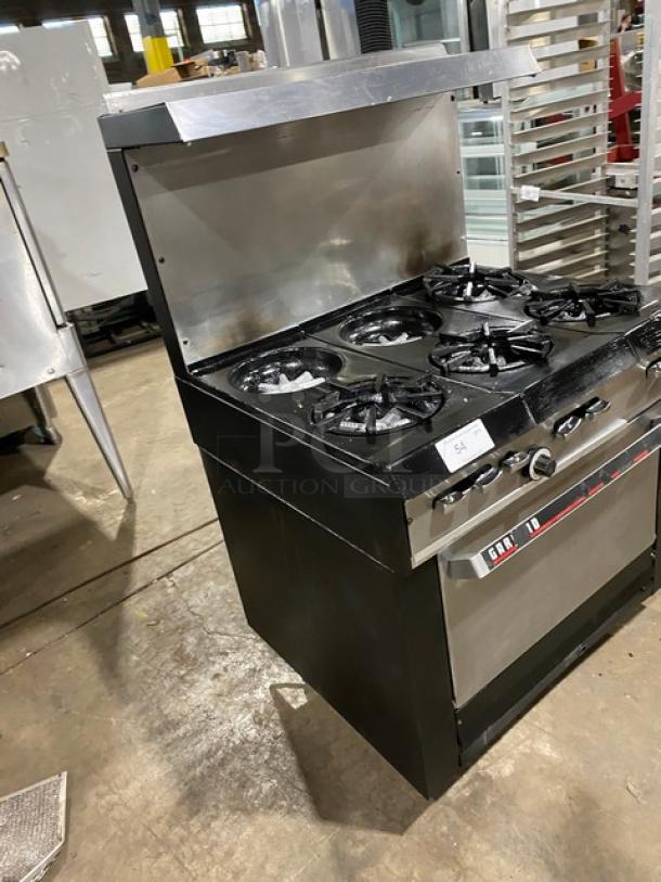 Garland stainless steel 6-burner gas range/oven combo with backsplash, overhead salamander shelf, and wire oven rack on legs.