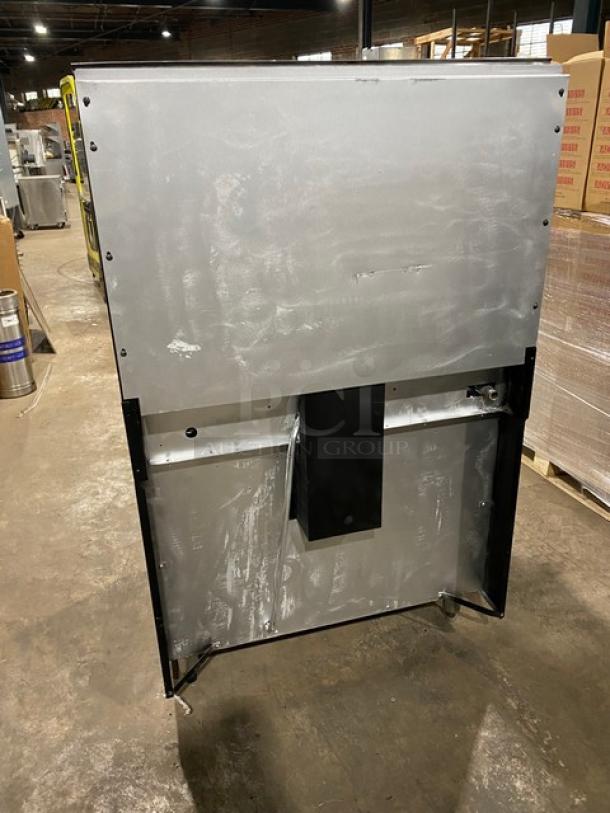 Garland stainless steel 6-burner range/oven combo, natural gas, with backsplash, overhead salamander shelf, wired oven rack, on legs.