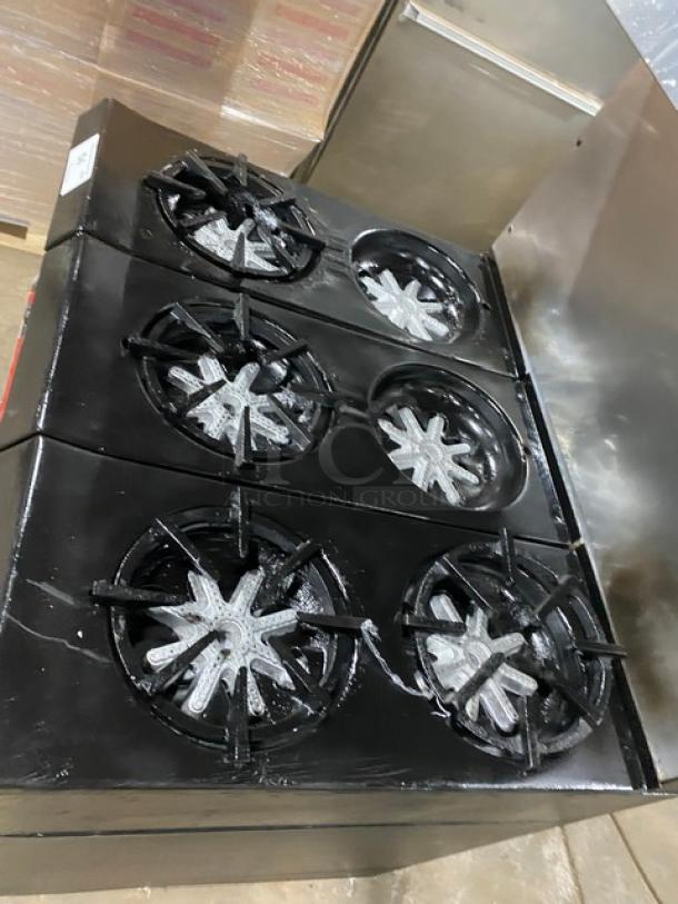 Garland commercial stainless steel 6-burner gas range/oven combo with backsplash, overhead salamander shelf, and wired oven rack.