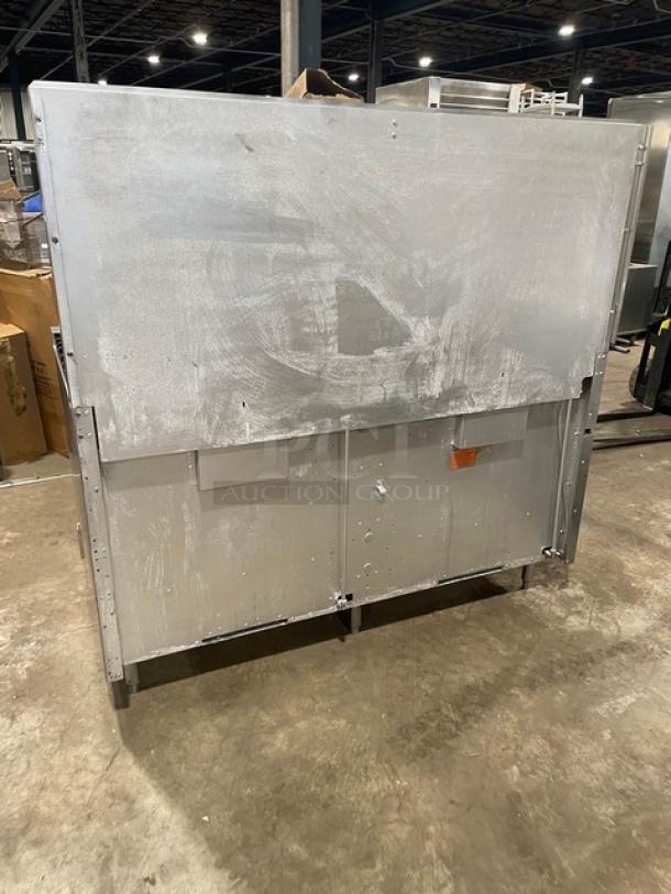 Vulcan commercial stainless steel gas-powered griddle and range combo with double oven, backsplash, and oven rack, on legs.