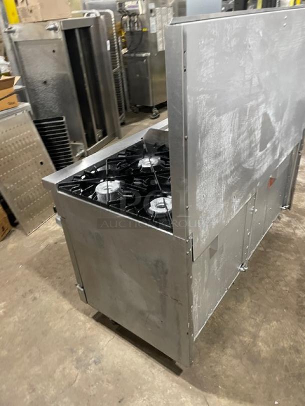Vulcan commercial stainless steel griddle range with split-top, 4 burners, double oven, backsplash, and wired rack on legs.