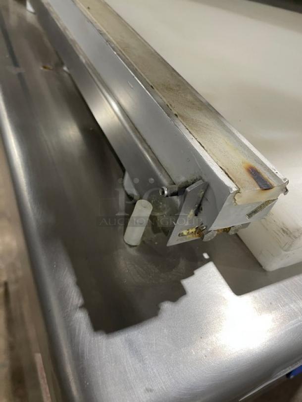 Promax stainless steel single chamber vacuum tray sealer with digital controls on casters, showing corner detail.