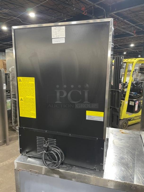Summit FF64BCSS all-refrigerator, stainless steel, 24" single door, adjustable shelving, shown from the back, model details visible.