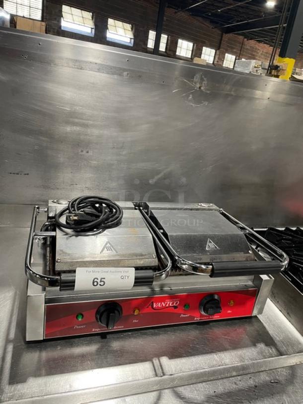 Avantco commercial stainless steel dual panini grill with grooved grates, thermostatic control, used condition, model plate visible.