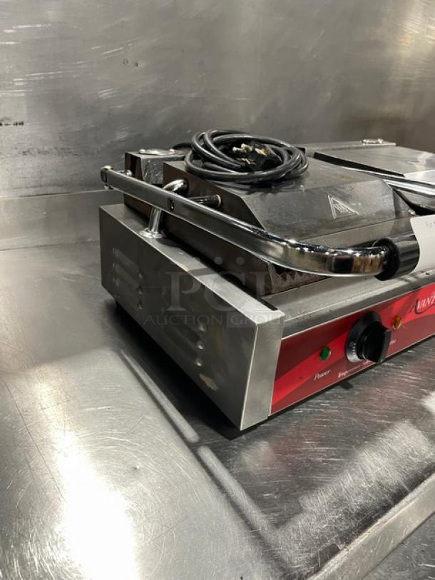 Avantco stainless steel dual panini grill with thermostatic control, top and bottom grooved grates, power switch, and cord.