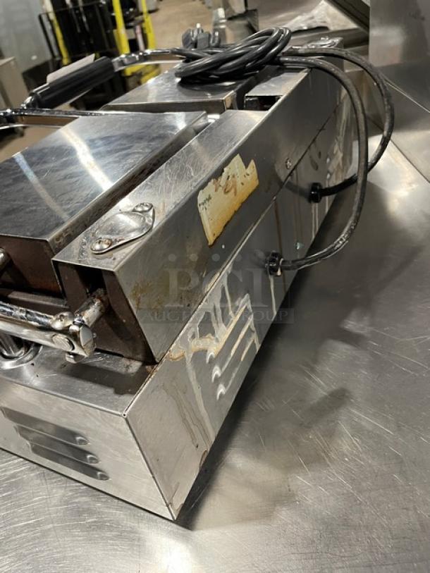 Avantco commercial dual panini grill with stainless steel body, grooved grates, and thermostatic control. Used condition.