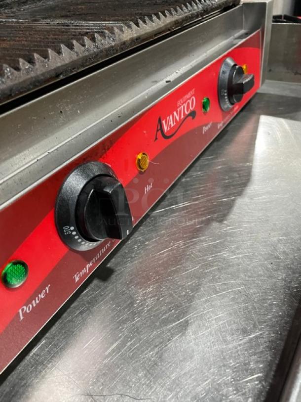 Avantco commercial stainless steel countertop dual panini grill with thermostatic control, grooved grates visible.